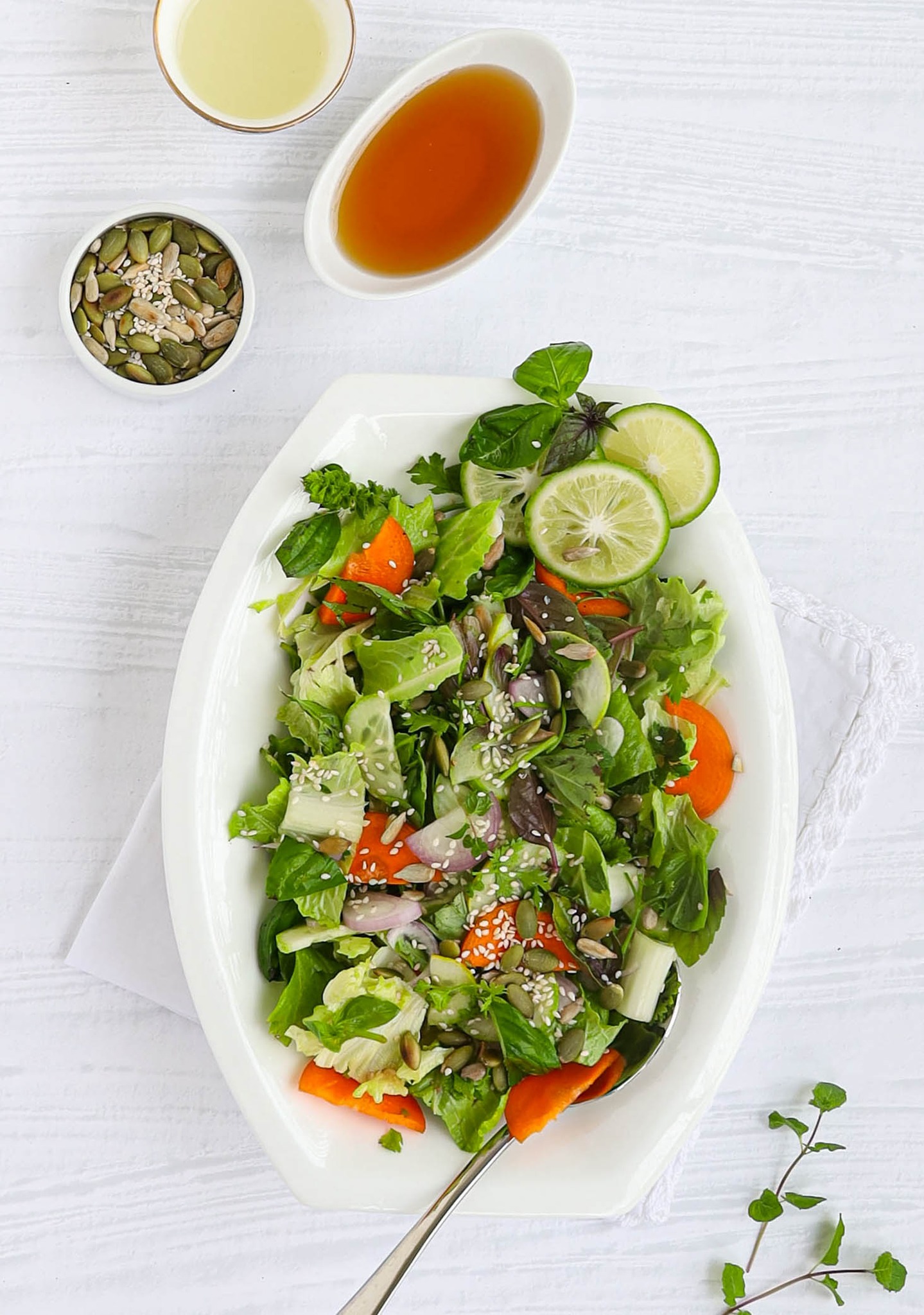 Plate with salad and bowl with sauce